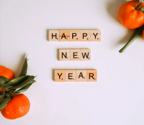 Letter tiles beside mandarins-