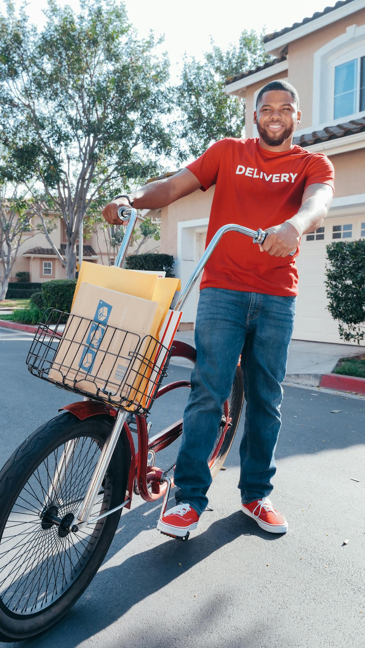 A delivery worker with his package in a trolley.