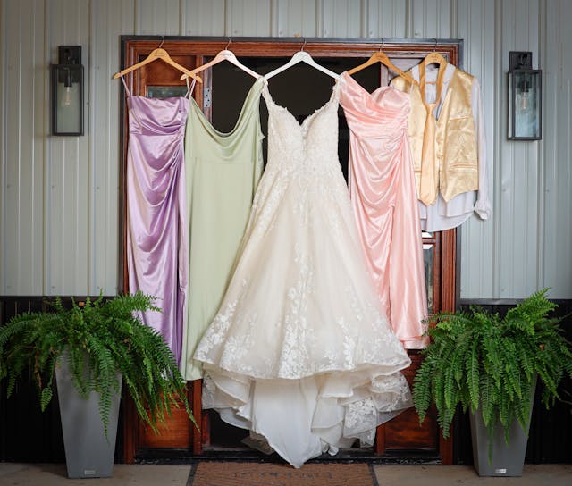 Wedding outifts hanging next to each other on coat hangers
