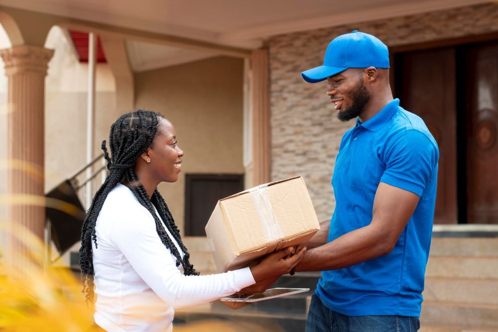 close-up-delivery-person-giving-parcel-client