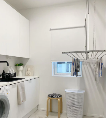 A Foxydry mini ceiling mounted drying rack in a laundry room