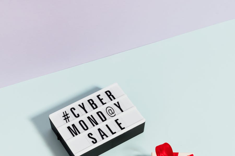 A white and black sign saying Cyber Monday Sale with a gift box