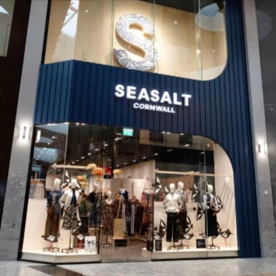 A Seasalt Cornwall shop with a range of men and women's clothes through the glasses