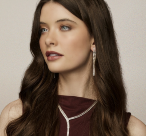 A lady wearing a brown top and a gold jewellery set from Argento