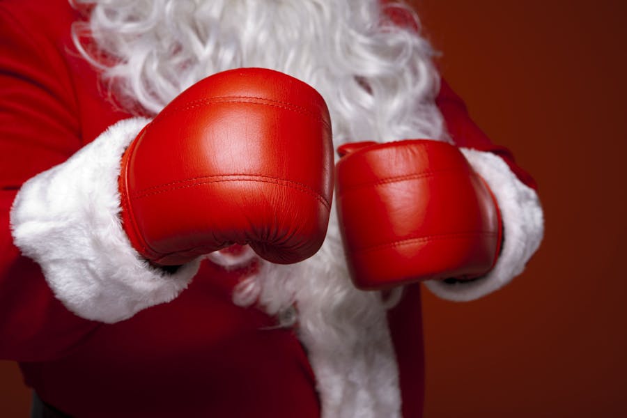A santa claus wearing red boxing gloves to show the spirit of Boxing Day