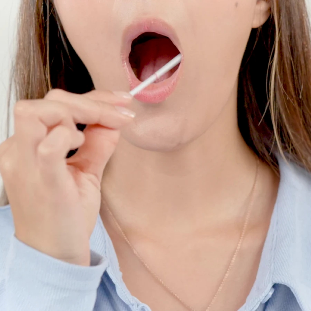 Woman using CircleDNA at-home DNA cheek swab test kit