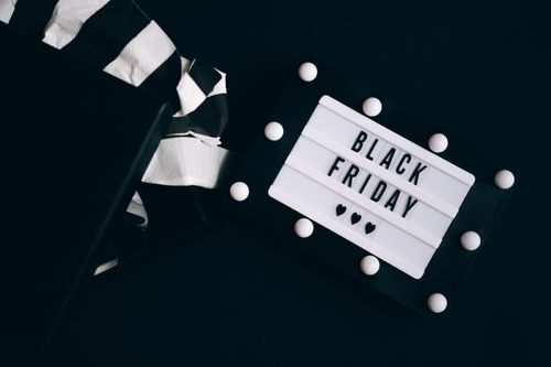 A black and white sign with the words "Black Friday" on it. Save this Black Friday with Black Friday promo codes from Love Coupons