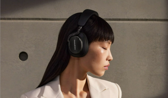 A woman wearing black Bowers & Wilkins Px8 S2 Over-ear noise-cancelling headphones