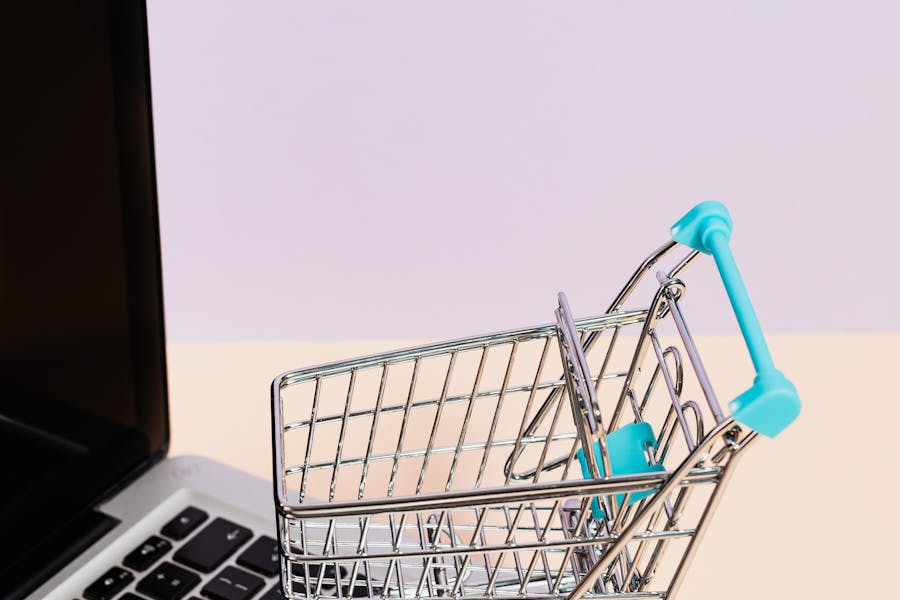 A black screen laptop with a shopping cart sitting on it