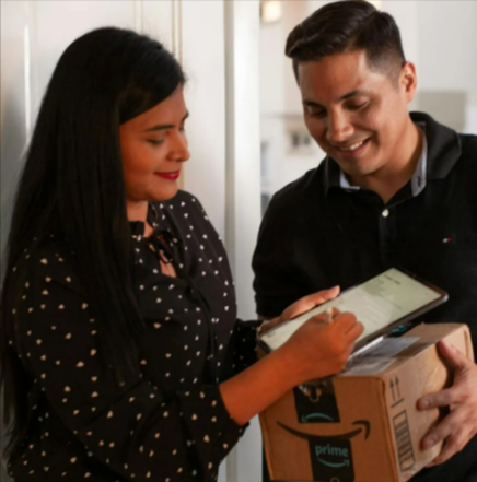A lady signing for her Amazon Prime package