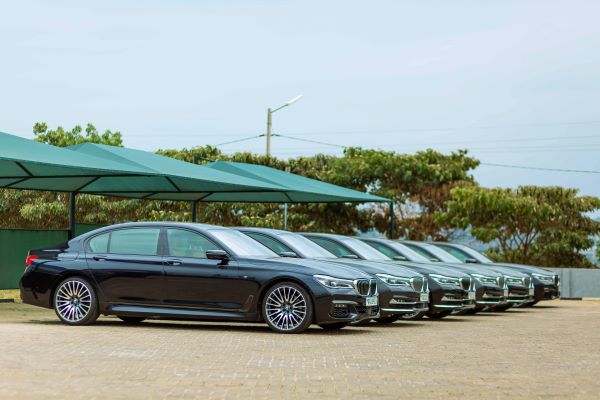 A fleet of luxury cars under a car parking shade