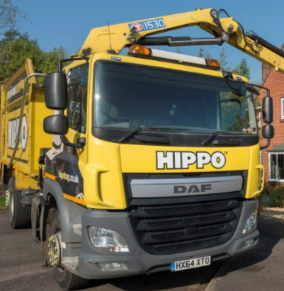 A Hippo skip being dropped at a driveway
