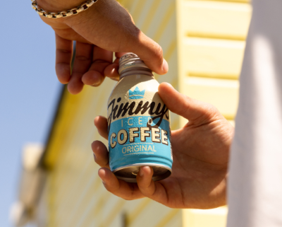 Hands opening a can of Jimmy's Iced Coffee's Original flavour outdooors