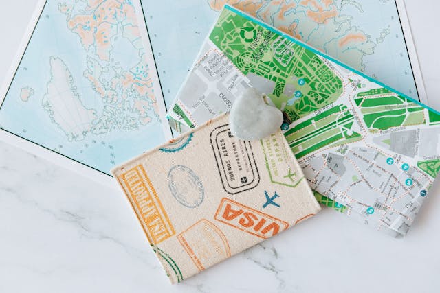 Last minute holiday deals: Two maps and a visa application a white surface