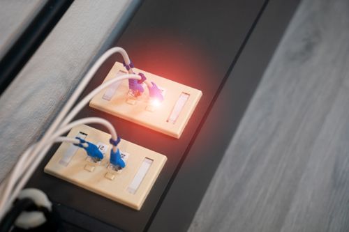 WiFi routers plugged into an outlet that someone saved on with a HeyBroadband voucher code from Love Discount Vouchers