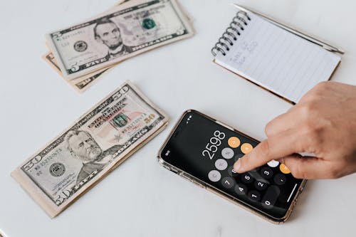 A person calculating how much money they saved with Panaracer