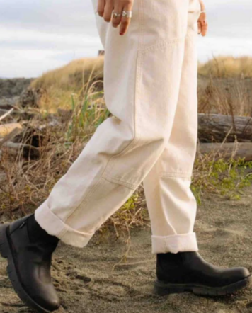 Cream jeans and boots with an outdoor background