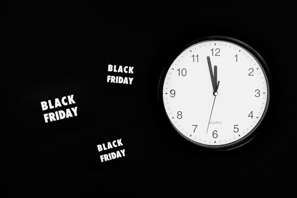 Black Friday signs next to a clock for Black Friday laptop specials
