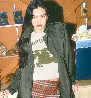 Lady wearing a green trenchcoat bought in the FLANNELS women's section using a FLANNELS discount code