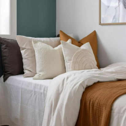 A bedroom with white and brownish bed linen from Atlas For Men