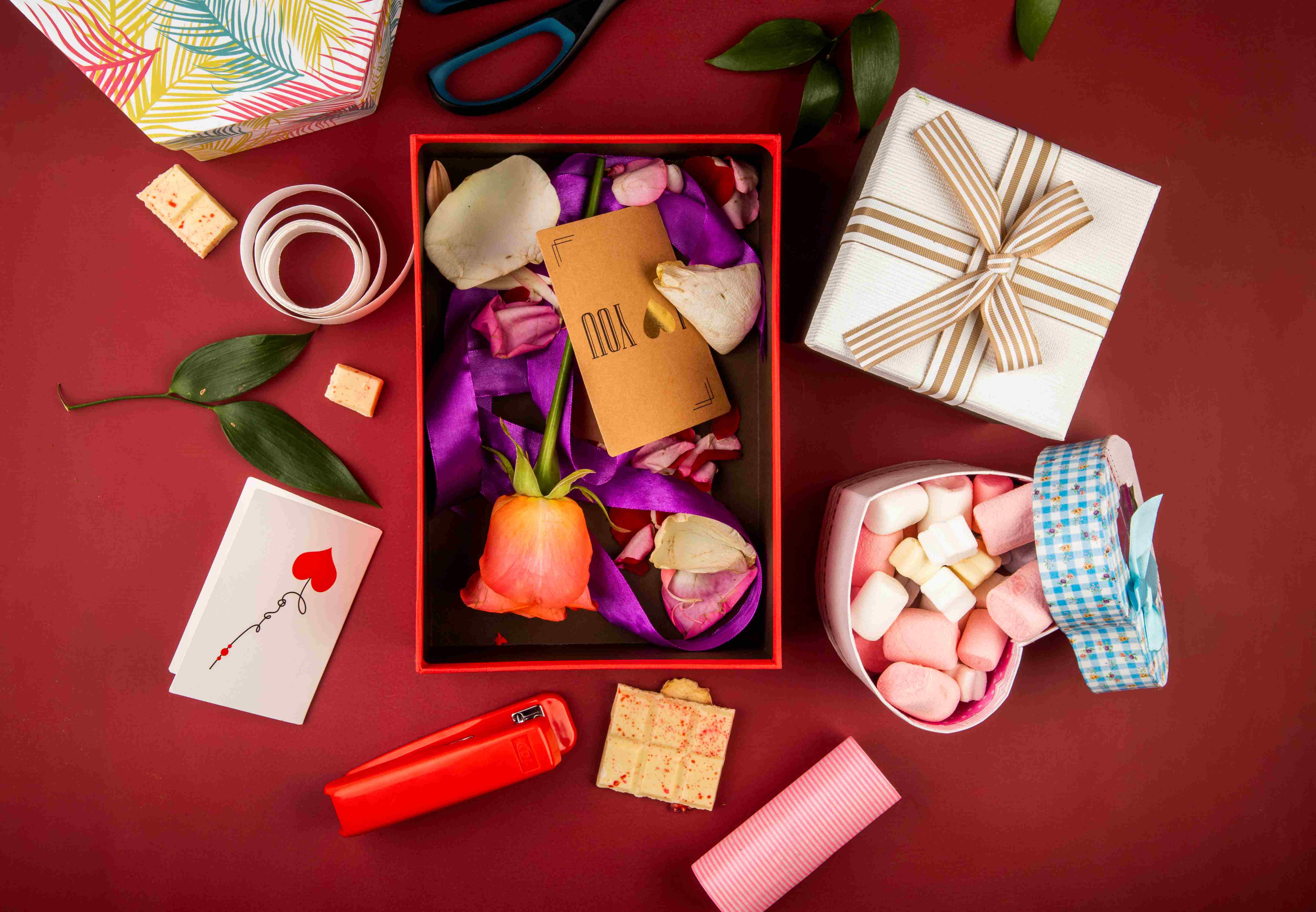 top-view-red-present-box-with-brown-paper-card-coral-color-rose-flower-petals