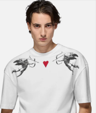 A man wearing a cherub graphic white t-shirt from Fiorucci