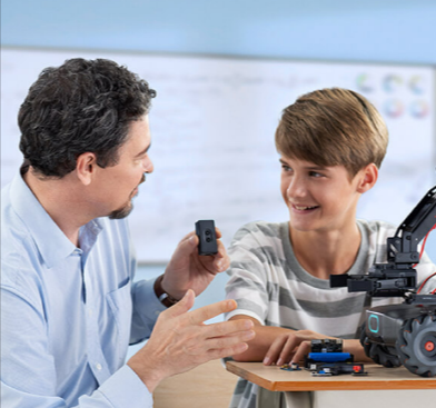 A father and a son assembling a DJI camera