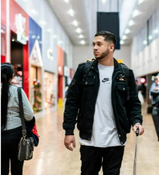 Man walking through modern airport terminal