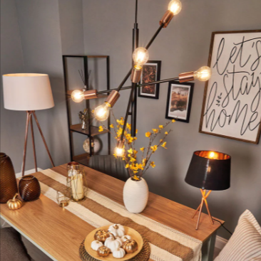 A wooden table with decorative items on it and various lighting elements