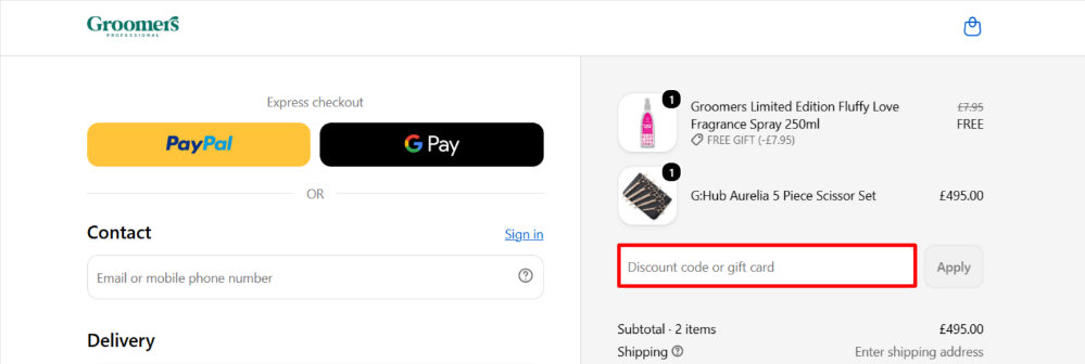 Applying a Groomers promo code at checkout to save money.
