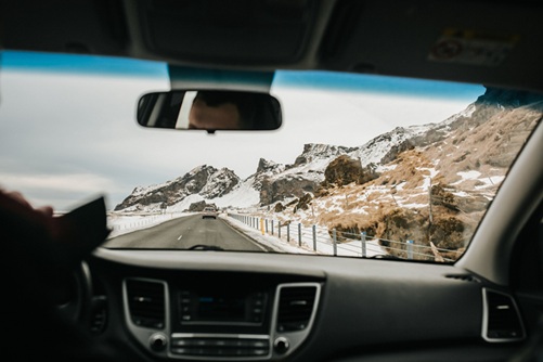 image showing the view of a mountain from inside a car