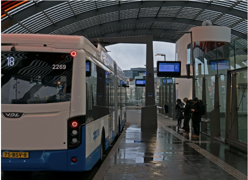 A shuttle waiting to pick up passengers and dropping them off at different destinations