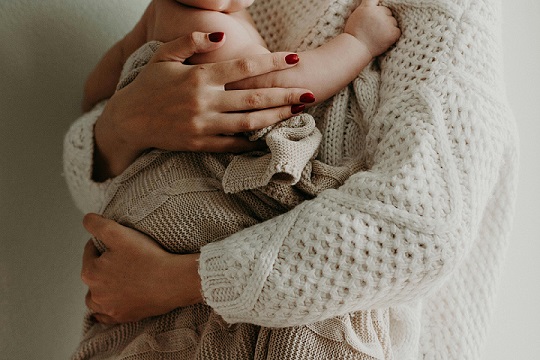 image showing a woman cradling a child 