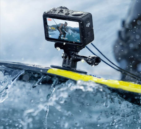 A person surfing and capturing the experience with a DJI camera