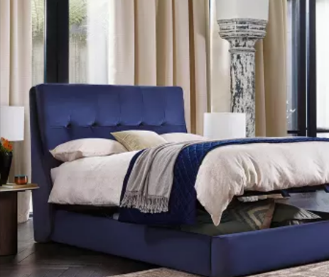 A blue bed with hidden storage and bedding from Furniture Village